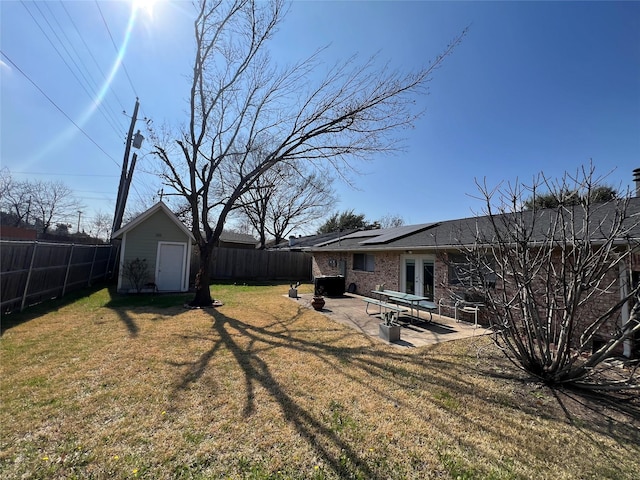 view of yard with a shed and a patio area