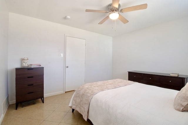 bedroom with ceiling fan, baseboards, and light tile patterned floors