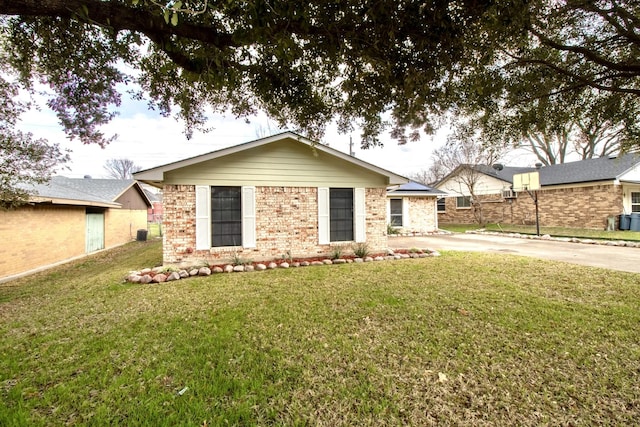 ranch-style house featuring a front yard, concrete driveway, and brick siding