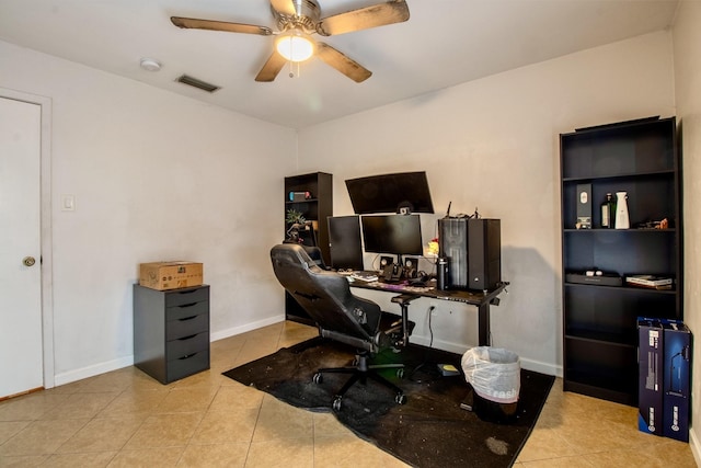 home office with ceiling fan, light tile patterned flooring, visible vents, and baseboards