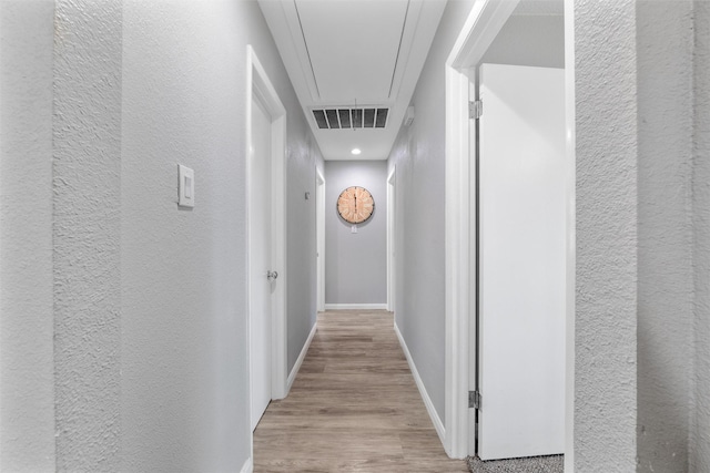 corridor with light wood-type flooring