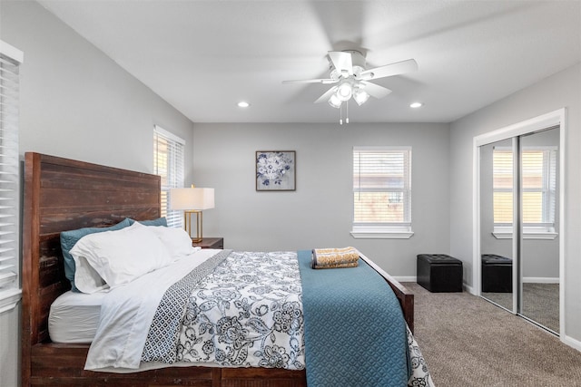 bedroom with multiple windows, a closet, ceiling fan, and carpet