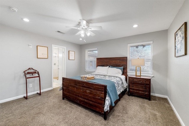 bedroom featuring ensuite bathroom, carpet floors, and ceiling fan