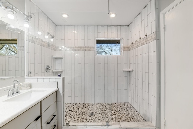 bathroom featuring vanity and a tile shower