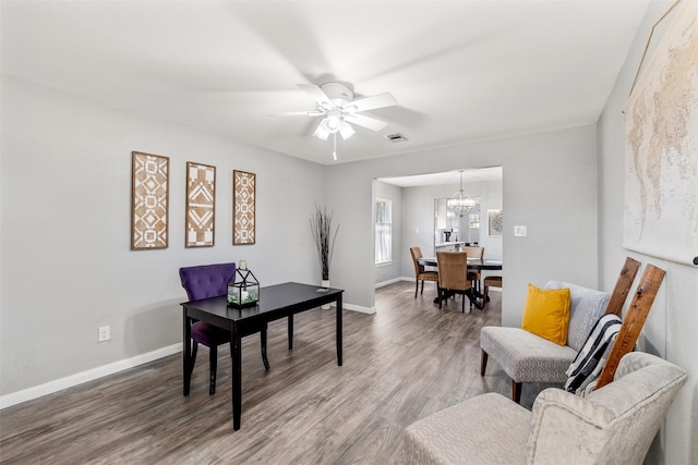 office space featuring hardwood / wood-style flooring and ceiling fan with notable chandelier