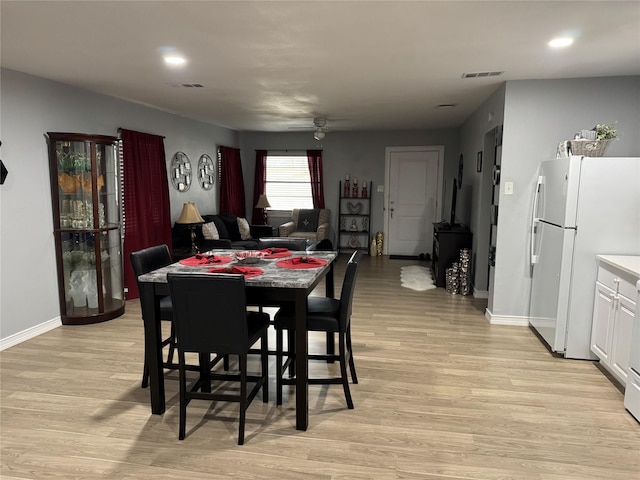 dining room featuring ceiling fan and light hardwood / wood-style flooring