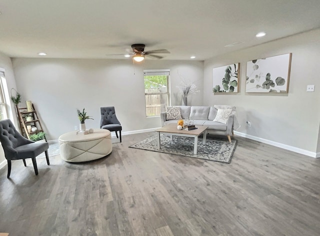 living room featuring hardwood / wood-style floors and ceiling fan