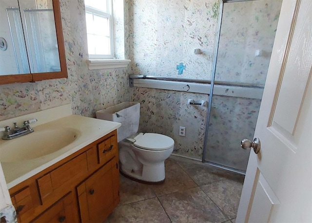 bathroom with tile patterned flooring, vanity, and toilet