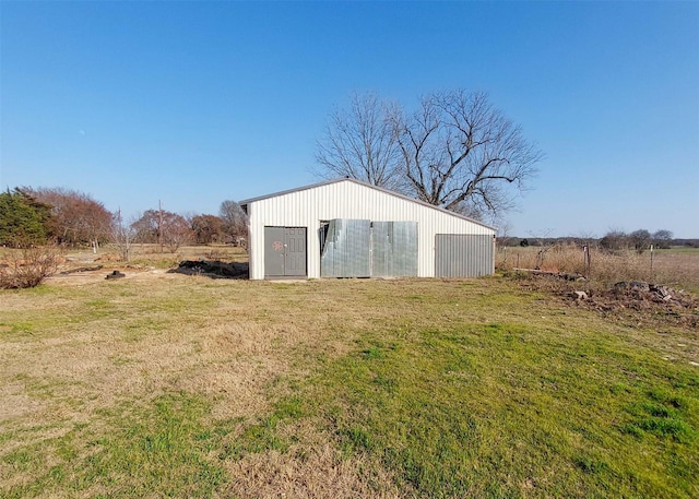 view of outbuilding with a yard