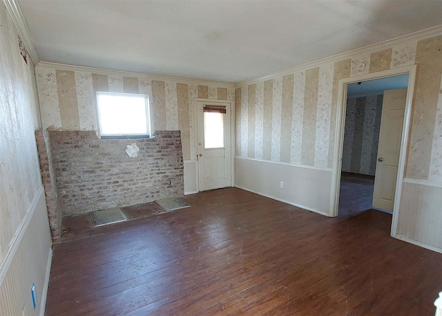 unfurnished room with dark wood-type flooring and ornamental molding