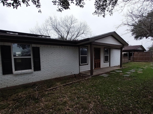 back of property featuring a yard