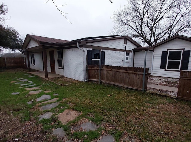 back of house with a lawn