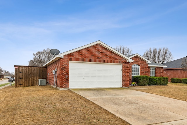 view of front facade featuring a garage, central AC, and a front lawn