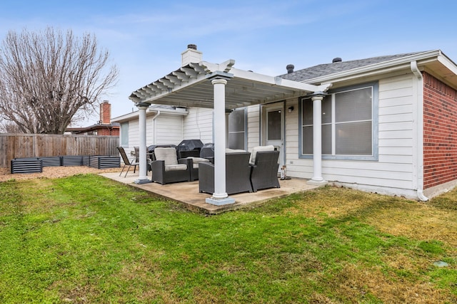 back of house featuring outdoor lounge area, a patio, and a lawn