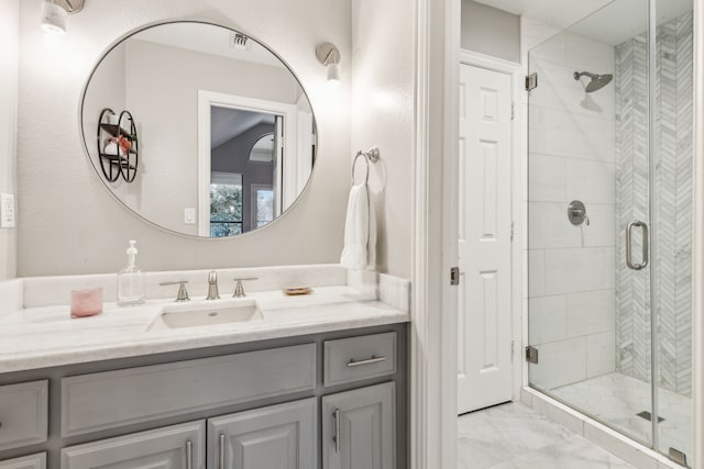 bathroom featuring vanity and an enclosed shower