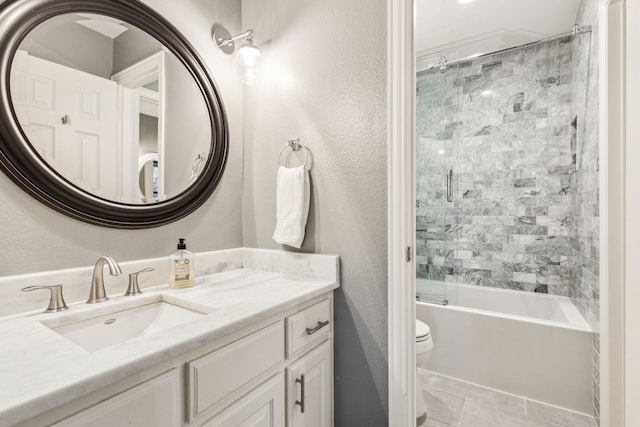 full bathroom with toilet, tile patterned flooring, combined bath / shower with glass door, and vanity