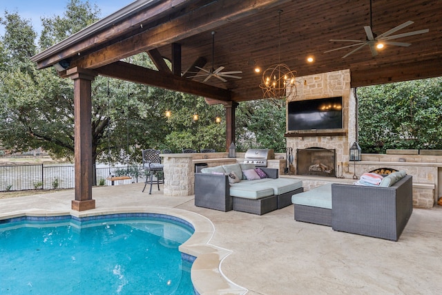 view of swimming pool featuring an outdoor bar, area for grilling, a patio area, and an outdoor stone fireplace