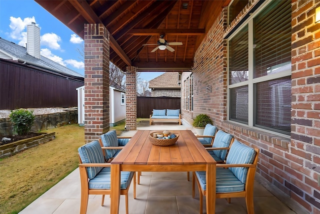 view of patio / terrace featuring an outdoor hangout area, ceiling fan, outdoor dining space, and fence