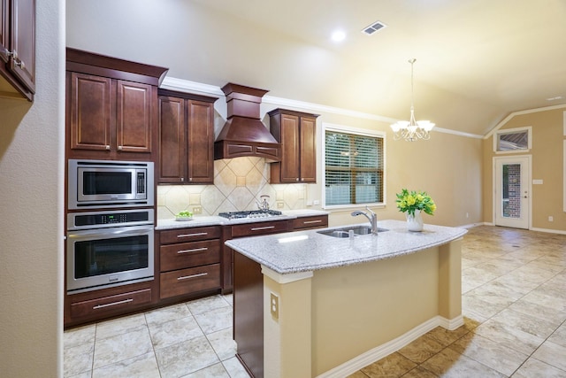 kitchen with premium range hood, lofted ceiling, a sink, stainless steel appliances, and backsplash