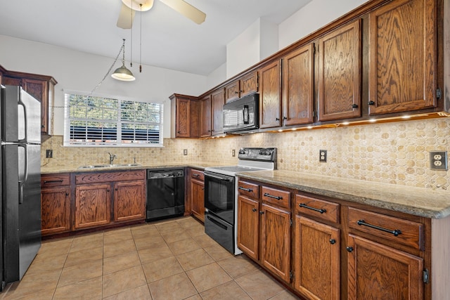 kitchen featuring light tile patterned flooring, sink, light stone counters, tasteful backsplash, and black appliances