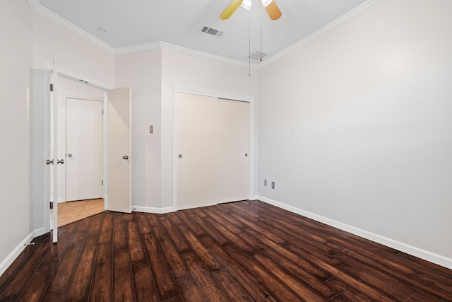 unfurnished bedroom featuring a closet, crown molding, dark hardwood / wood-style floors, and ceiling fan