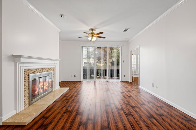 unfurnished living room featuring dark hardwood / wood-style flooring, crown molding, a premium fireplace, and ceiling fan