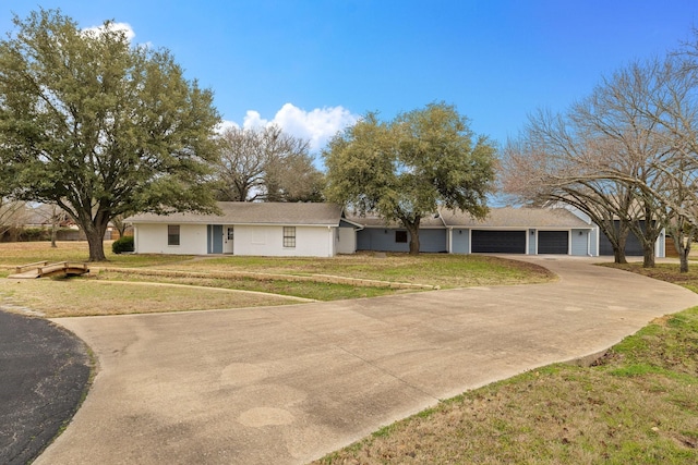 single story home with a garage and a front yard