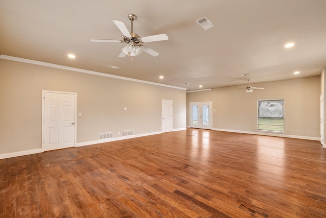 empty room with ornamental molding, hardwood / wood-style floors, ceiling fan, and french doors