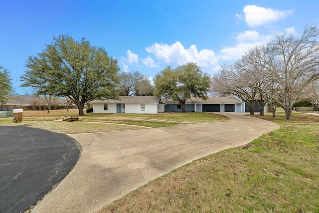 ranch-style home featuring a garage and a front lawn