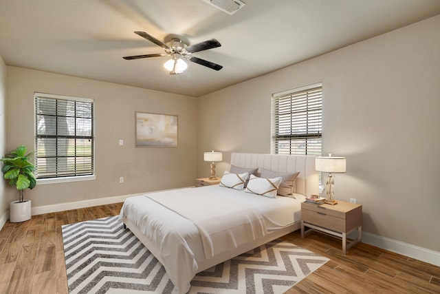 bedroom with ceiling fan and light hardwood / wood-style floors