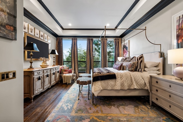 bedroom featuring a tray ceiling, dark wood-type flooring, and ornamental molding