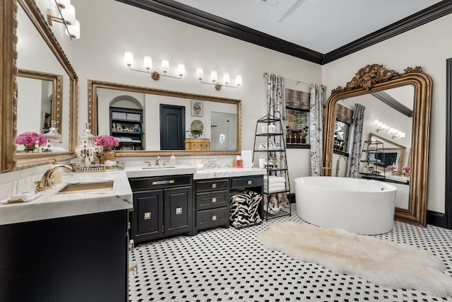 bathroom with vanity, ornamental molding, and a tub