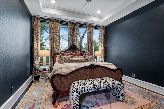 bedroom with crown molding and a raised ceiling