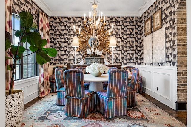 dining space featuring ornamental molding, hardwood / wood-style floors, and a notable chandelier