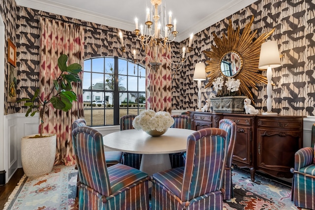 dining room with hardwood / wood-style flooring, ornamental molding, and a notable chandelier