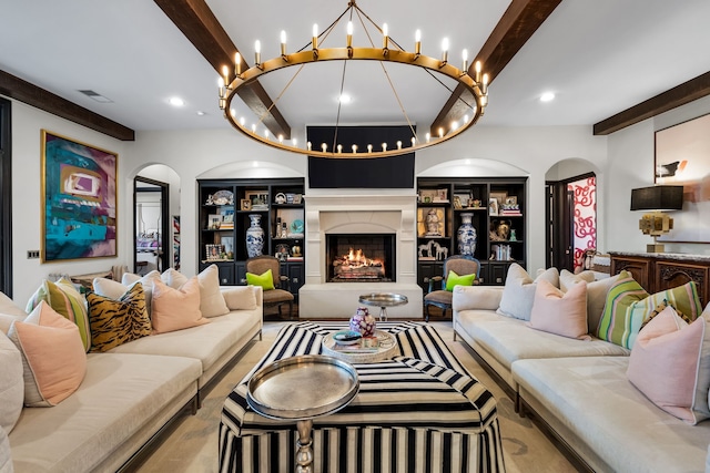 living room featuring a high end fireplace, beam ceiling, and built in features