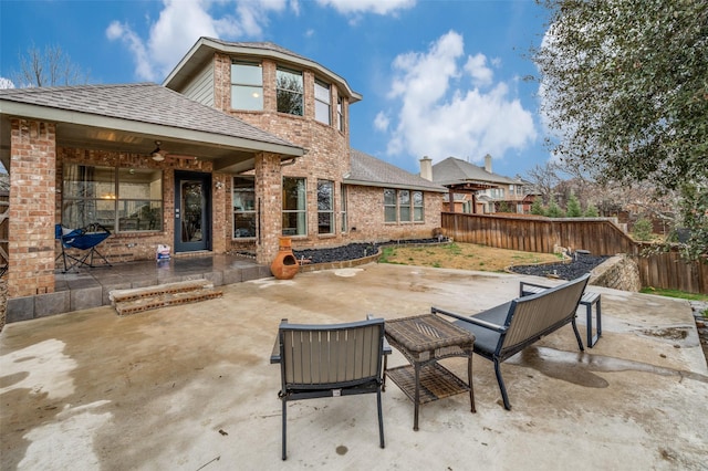 rear view of property with ceiling fan and a patio