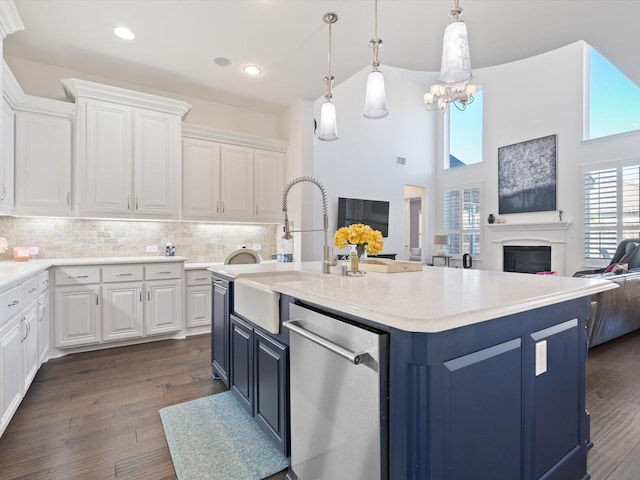 kitchen with white cabinetry, hanging light fixtures, dark hardwood / wood-style flooring, and dishwasher