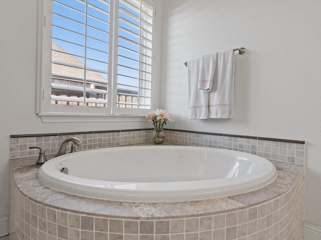 bathroom with a relaxing tiled tub