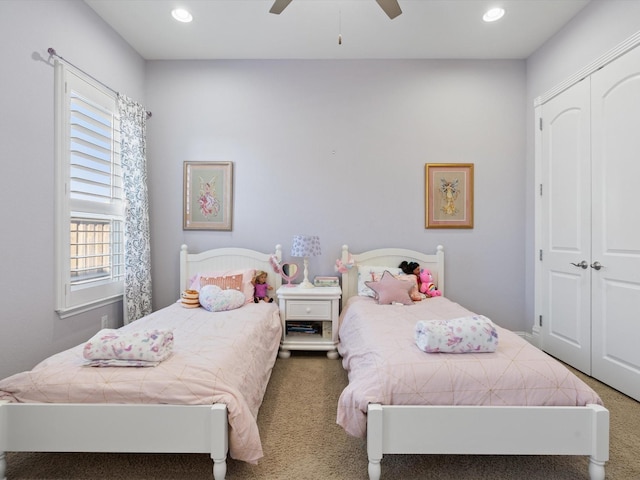 carpeted bedroom with a closet and ceiling fan