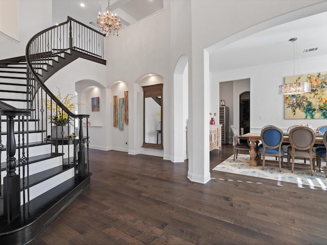 entryway with a notable chandelier and dark wood-type flooring