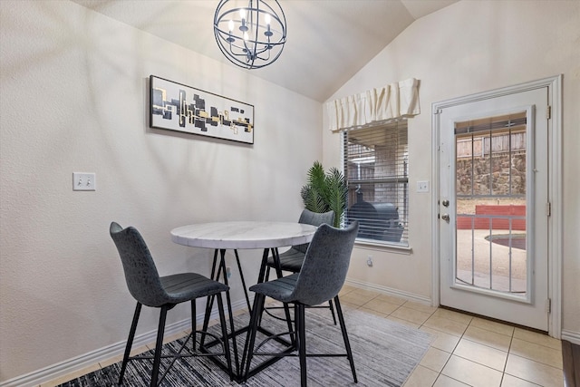 dining room with light tile patterned floors, a chandelier, vaulted ceiling, and a wealth of natural light