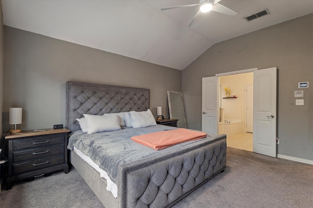 carpeted bedroom featuring ensuite bathroom, lofted ceiling, and ceiling fan