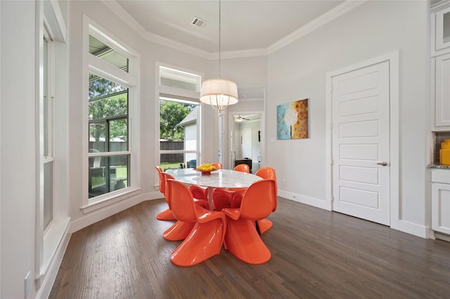 dining area featuring baseboards, crown molding, visible vents, and dark wood-style flooring