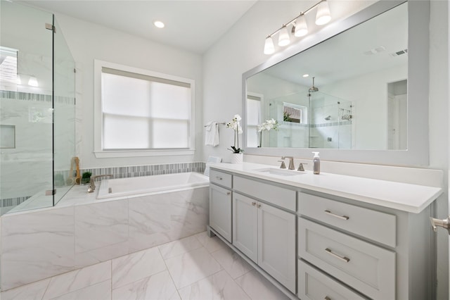 bathroom with visible vents, vanity, marble finish floor, a marble finish shower, and a bath