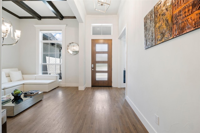 entryway with beam ceiling, baseboards, dark wood-type flooring, and a notable chandelier