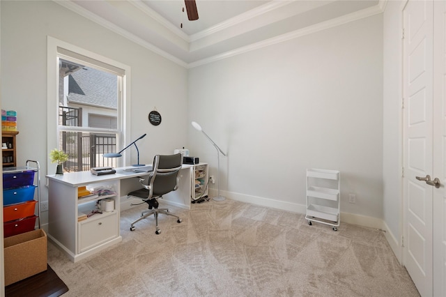 office space with baseboards, a tray ceiling, ornamental molding, and light colored carpet