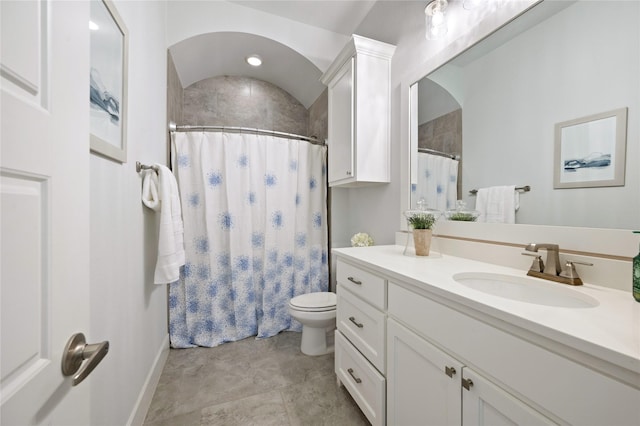 bathroom with toilet, curtained shower, baseboards, and vanity