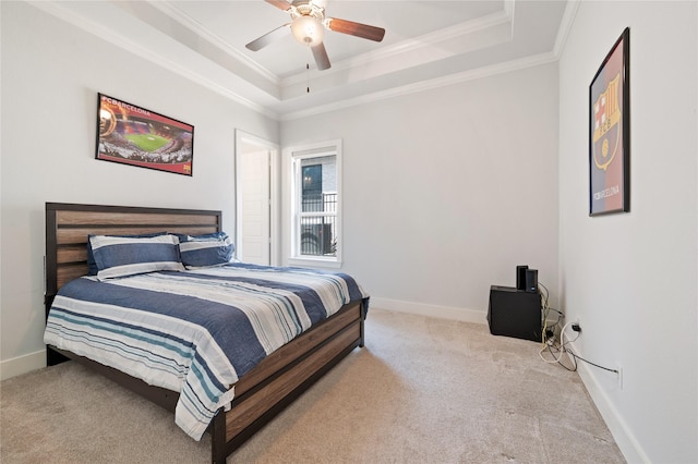 bedroom featuring baseboards, a raised ceiling, and light colored carpet