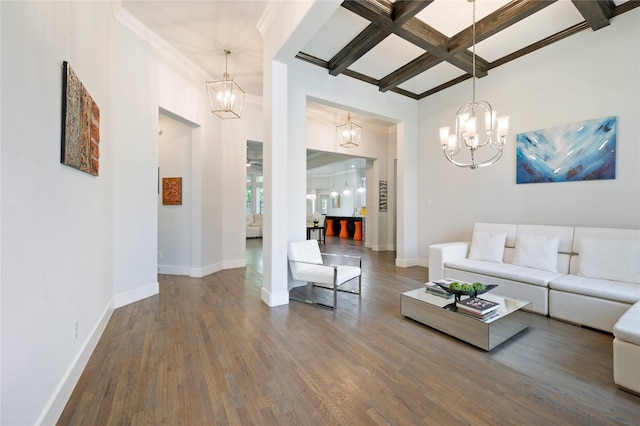 living area featuring baseboards, coffered ceiling, dark wood-style flooring, beamed ceiling, and a chandelier